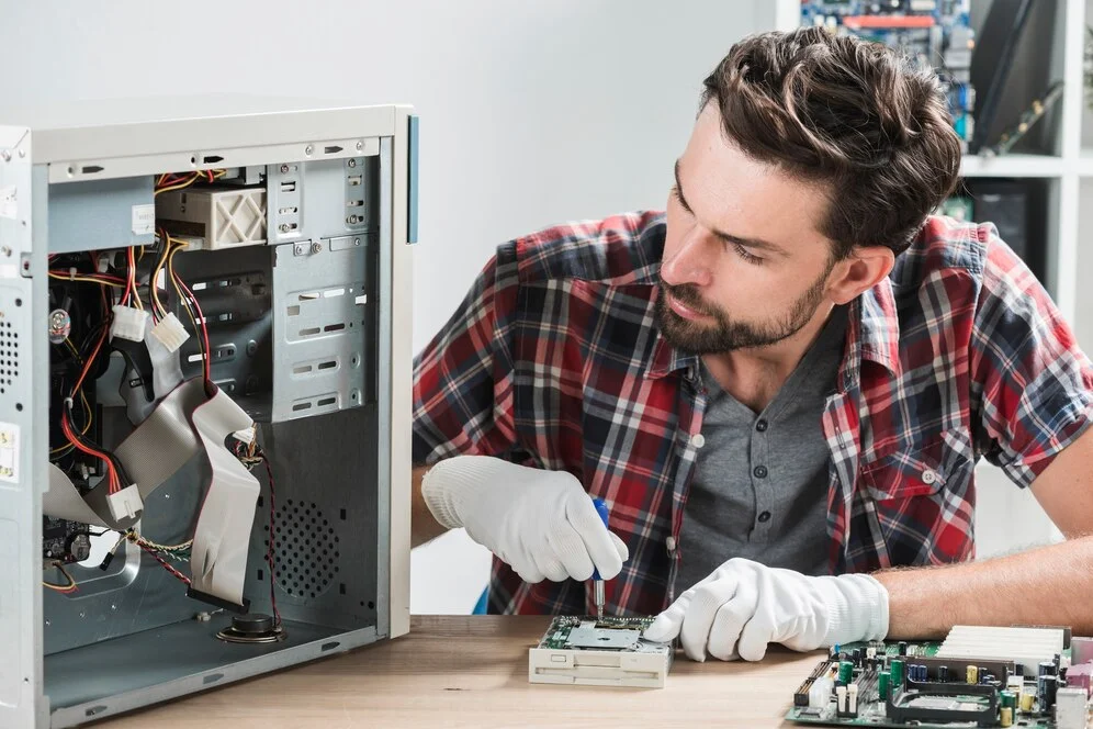 A technician performing a component-level repair, a key sign of the best computer repair shop near me.