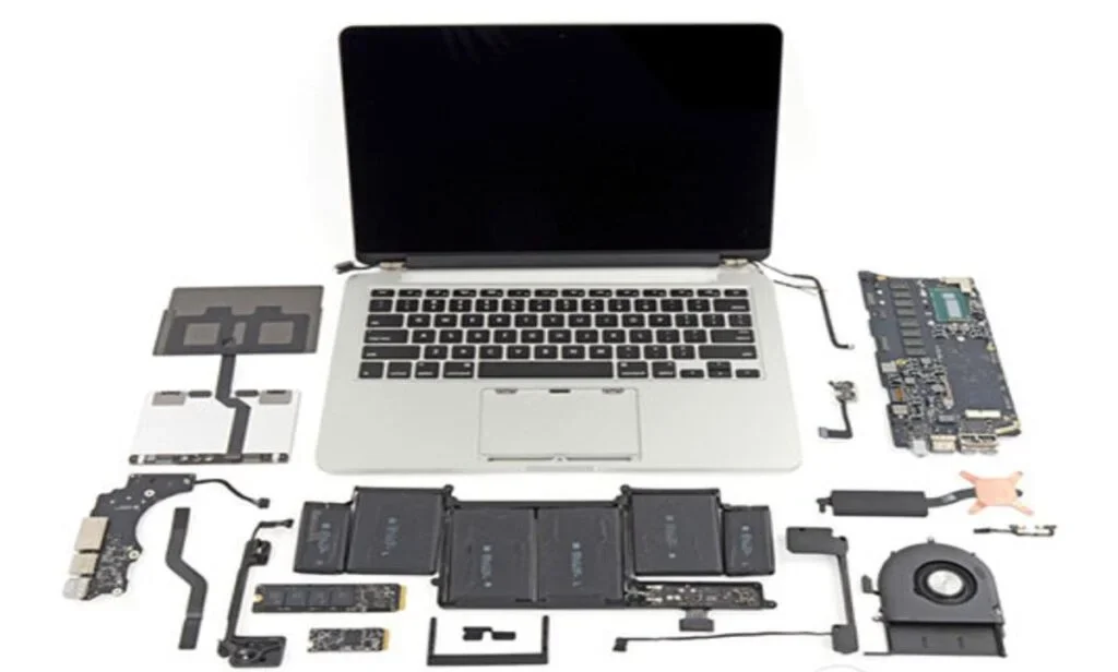 A technician performing expert MacBook repair London service on a logic board.
